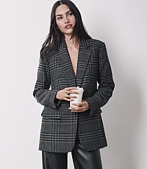 A woman in a plaid blazer and leather pants holds a coffee cup against a plain background. carousel Product Image 4