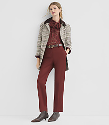 A woman in a patterned jacket and maroon pants stands against a plain white background. carousel Product Image 1