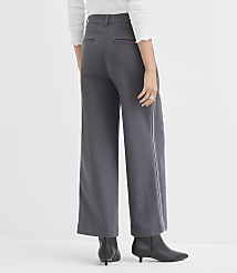 A person wearing wide-leg gray pants with a white stripe down the side and black boots stands against a plain white background. carousel Product Image 3