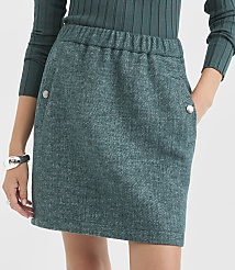 A woman in a teal skirt with pockets stands against a blurred background. carousel Product Image 2