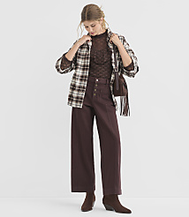 A woman in a brown plaid shirt and wide-leg pants stands against a plain white background. carousel Product Image 1