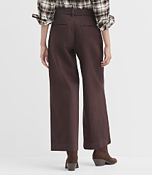 A person wearing a plaid shirt and brown wide-leg pants stands against a plain white background. carousel Product Image 3