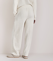 Cream cable-knit pajamas and slippers are shown against a plain, light background. carousel Product Image 3