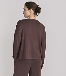 A woman in a brown ribbed top and pants stands with her back to the camera against a plain gray background. carousel Product Image 3