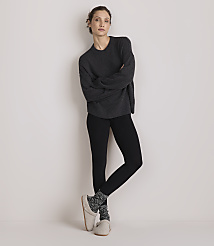A woman in a dark gray sweater and black leggings stands with her arms crossed against a plain white background. carousel Product Image 2