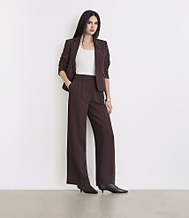 A woman in a brown suit stands against a plain white background. carousel Product Image 1