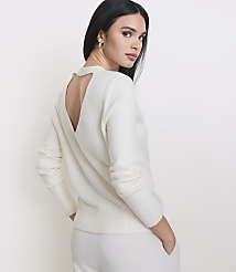 A woman in a cream sweater and pants stands against a plain white background. carousel Product Image 2