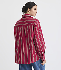 A woman in a red striped shirt and tan pleated skirt stands against a plain white background. carousel Product Image 3