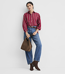 A woman in a striped red shirt and a tan pleated skirt stands against a plain white background. carousel Product Image 2