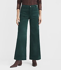A person stands in the foreground wearing wide-leg green corduroy pants and brown boots, against a plain white background. carousel Product Image 2