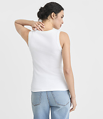 A woman in a white tank top and blue jeans stands with her back to the camera against a plain white background. carousel Product Image 3