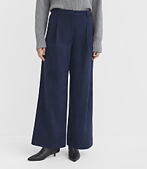 A person in a grey sweater and navy corduroy wide-leg pants stands against a plain white background. carousel Product Image 2