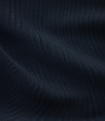 A dark blue, ribbed fabric with soft folds fills the frame, creating a textured and shadowed surface. carousel Product Image 4