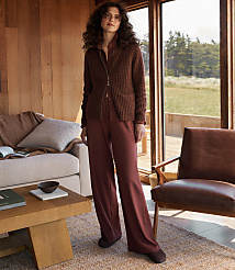 A woman stands in a cozy living room with a large window overlooking a grassy field. carousel Product Image 3