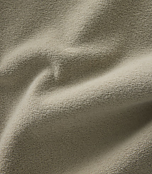 A close-up view of a textured, beige fabric with soft folds and shadows fills the frame. carousel Product Image 4