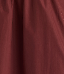 A close-up of a deep red, textured fabric fills the frame, with soft folds creating subtle shadows and highlights. carousel Product Image 3
