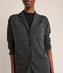 A woman in a dark grey blazer stands against a plain, light grey background. carousel Product Image 2