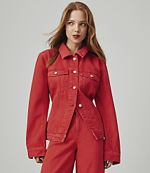 A young woman with red hair and a red denim jacket and pants stands against a plain gray background. carousel Product Image 6