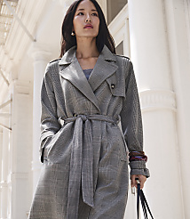 A woman in a plaid trench coat stands in front of a white building with columns. carousel Product Image 6
