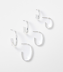 Three pairs of silver hoop earrings are arranged on a plain white background. carousel Product Image 1