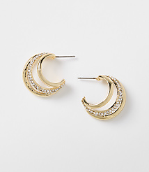 A pair of gold crescent-shaped earrings with clear rhinestones are displayed against a plain white background. carousel Product Image 1