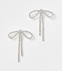Two sparkling bow-shaped earrings with dangling chains are set against a plain white background. carousel Product Image 1