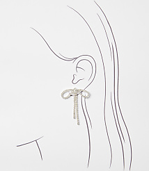 A sparkling bow earring with dangling chains adorns an illustrated ear against a plain white background. carousel Product Image 2