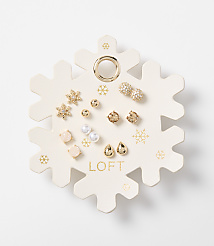 A snowflake-shaped card displays an assortment of small, decorative earrings in the foreground, set against a plain white background. carousel Product Image 1