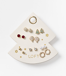 A white, Christmas tree-shaped earring display holds various festive earrings, with a plain white background. carousel Product Image 1