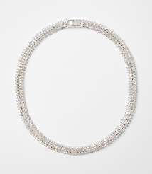 A sparkling, multi-layered rhinestone necklace with a silver clasp rests on a plain white background. carousel Product Image 1