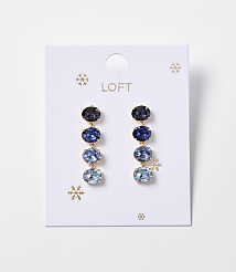 A pair of blue gemstone drop earrings with gold accents hangs from a white card with snowflake designs and the "LOFT" logo. carousel Product Image 1