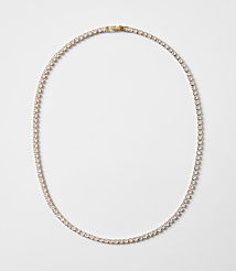 A delicate gold chain necklace with clear stones is laid out on a plain white background. carousel Product Image 1