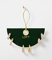 A set of gold-toned earrings, including studs and hoops, are displayed on a dark green card with the "LOFT" logo, against a plain white background. carousel Product Image 1