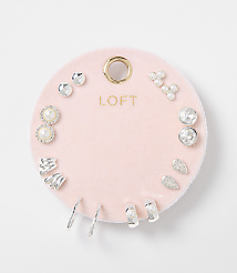 A collection of assorted silver and pearl earrings are displayed on a pink velvet circular backing with the "LOFT" logo, set against a plain white background. carousel Product Image 1