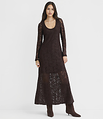 A woman in a long, dark brown lace dress and matching boots stands against a plain white background. carousel Product Image 1