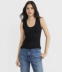 A woman in a black tank top and blue jeans stands against a plain white background. carousel Product Image 1