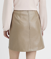 A person wearing a light pink sweater and a tan faux leather skirt stands against a plain white background. carousel Product Image 3
