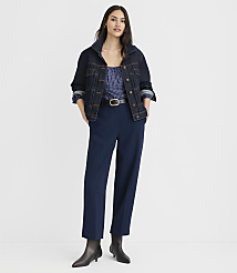 A woman in a denim jacket and blue pants stands against a plain white background. carousel Product Image 1