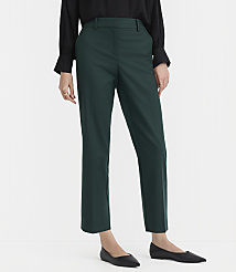 A person in a black shirt and green pants stands on a white background. carousel Product Image 1
