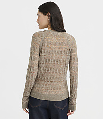 A woman in a sheer, textured brown sweater and dark jeans stands against a plain, light gray background. carousel Product Image 3