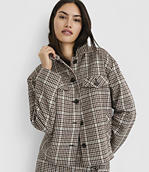 A woman in a plaid jacket stands against a plain white background. carousel Product Image 1