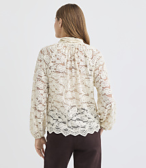 A woman in a cream lace blouse stands against a plain white background. carousel Product Image 4