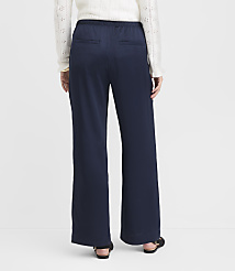 A person wearing navy wide-leg pants and a white sweater stands against a plain white background. carousel Product Image 3
