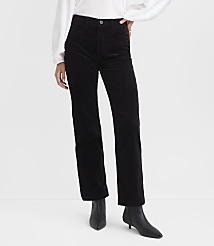Black corduroy pants and black heeled boots are in the foreground, against a plain white background. carousel Product Image 2