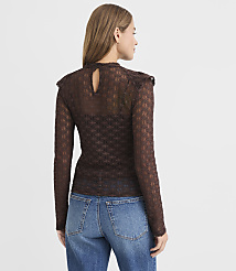 A woman in a sheer, patterned brown top and blue jeans stands against a plain white background. carousel Product Image 3