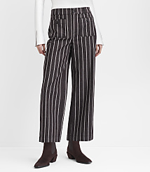 A person stands in front of a white background wearing brown and white striped wide-leg pants and dark brown boots. carousel Product Image 2