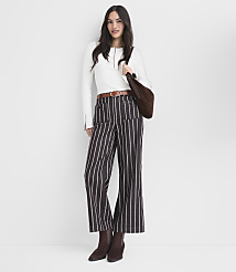 A woman in striped pants and a white top stands against a plain white background. carousel Product Image 1
