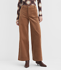 A person wearing brown corduroy wide-leg pants and a patterned long-sleeved shirt stands against a plain white background. carousel Product Image 2