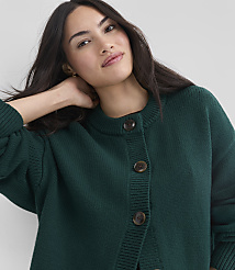A woman in a green cardigan with dark hair is posed against a plain gray background. carousel Product Image 4