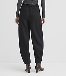 A person wearing black, wide-leg pants and brown boots stands against a plain, light gray background. carousel Product Image 3